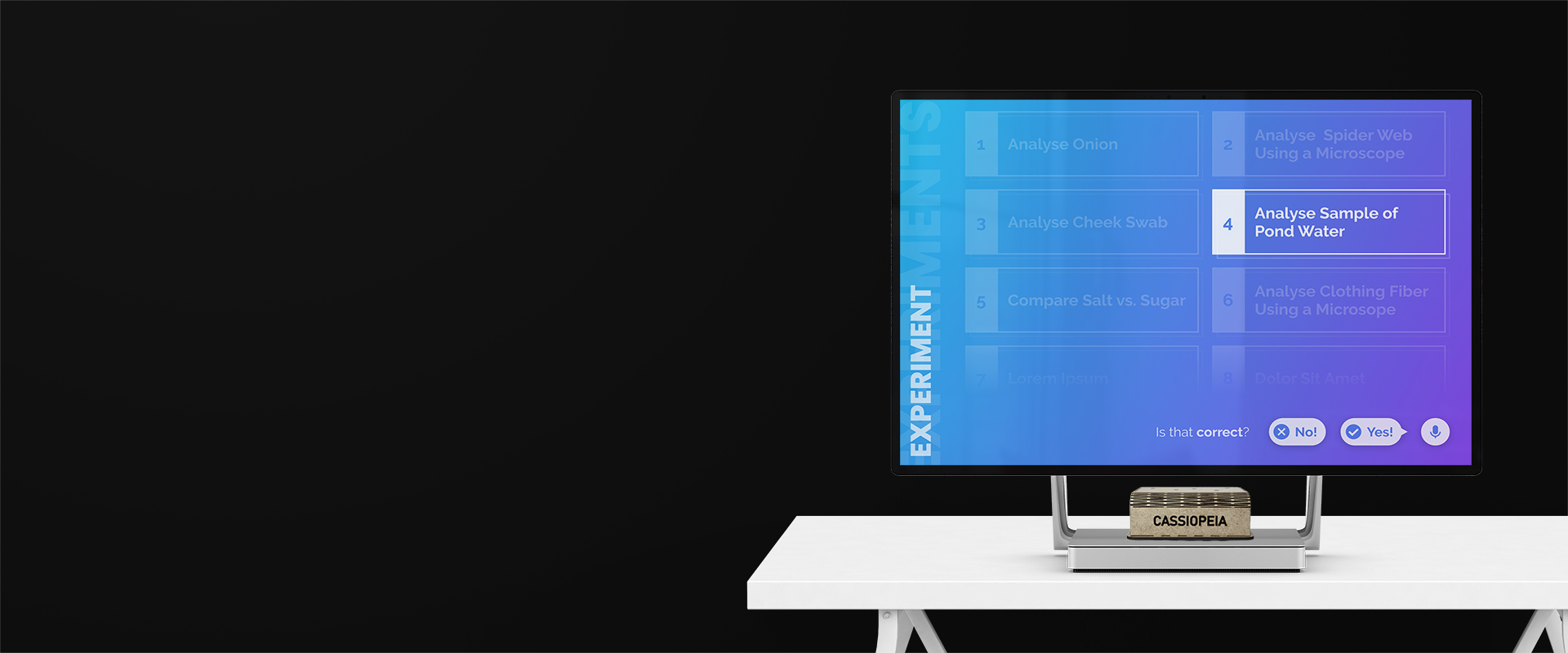 A photo of a Cassiopeia physical case in form of a wooden box and a large monitor showing Cassiopeia's user interface.